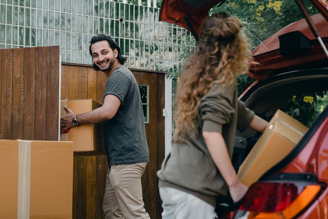 Couple loading their car and preparing for their NYC move